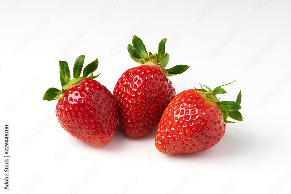 Three red strawberries on a white background Three red strawberries on a white background