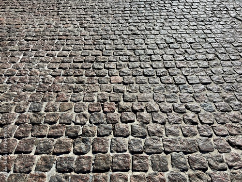 Quadro su tela cobblestone stone pavement street background.