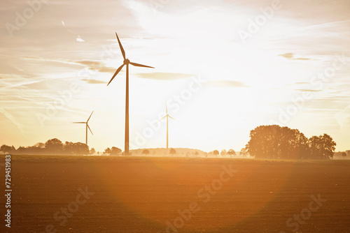 Windmills in the landscape at sunset. Munich, Germany photo