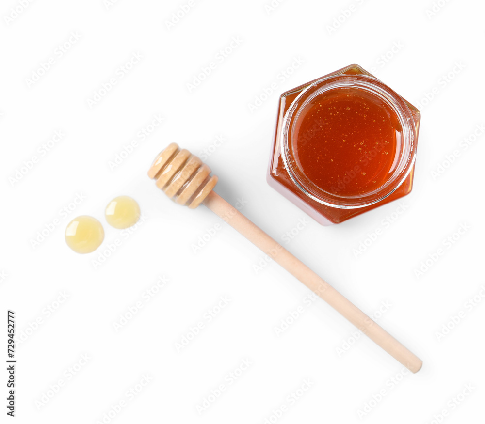Tasty natural honey, glass jar and dipper on white background, top view Tasty natural honey, glass jar and dipper on white background, top view
