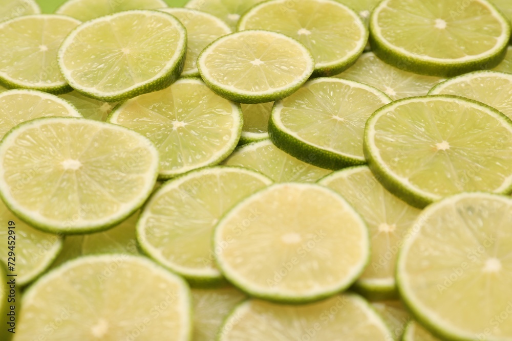 Many juicy lime slices as background, closeup view