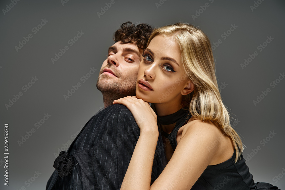 portrait of beautiful blonde woman looking at camera and leaning on shoulder of handsome man portrait of beautiful blonde woman looking at camera and leaning on shoulder of handsome man