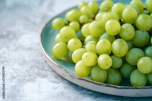 Professional food photo. Ad for healthy lifestyle, fitness. Plate with green grapes. Fruits