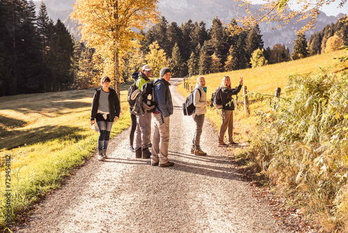 Group of friends hiking in the mountains in the fall. Lenggries, Bavaria, Germany