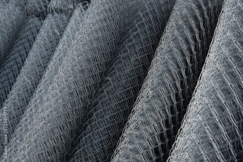 Coil of steel wire. Rabitz mesh netting roll  as background. Construction iron wire or mesh in a roll. Mesh wire rolls of iron stainless steel, galvanized metal sheets.  wire mesh rolls farm fence photo