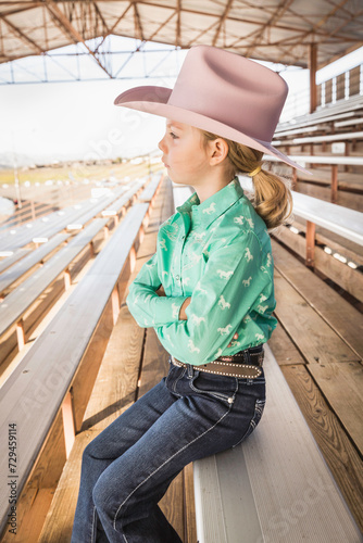 Young girl dressed in cowboy dress with hat and boots. Cody, Wyoming, USA photo