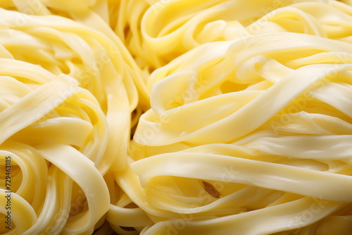 This photograph captures the subtle beauty of udon noodle texture in delicate white and yellow tones  highlighting the noodle s thick and chewy nature