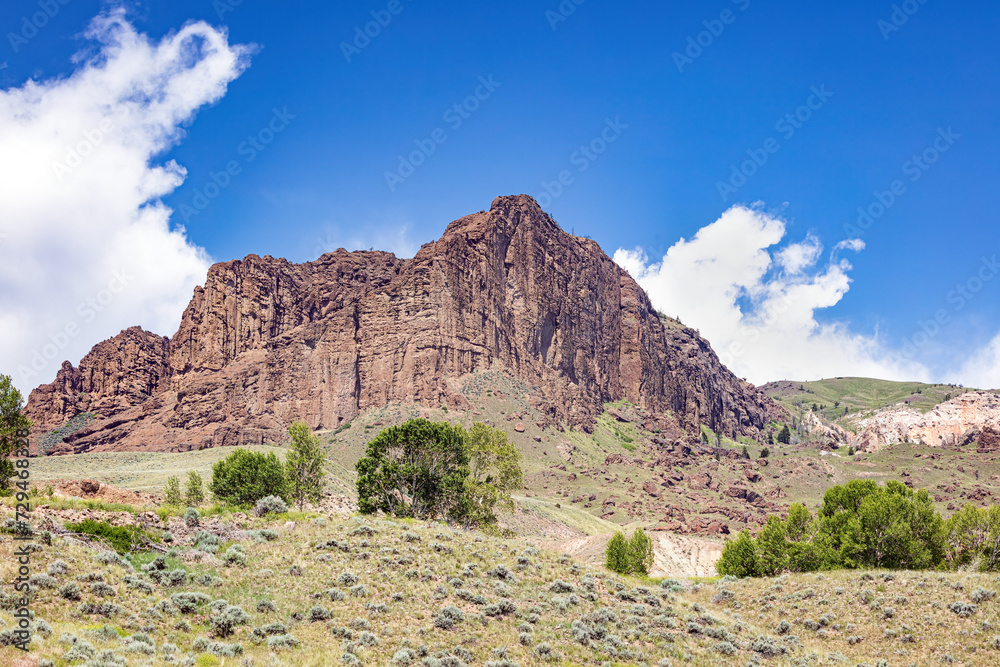 Prairie butte and hill summer landscape with blue-sky and clouds in northwest Wyoming, USA.