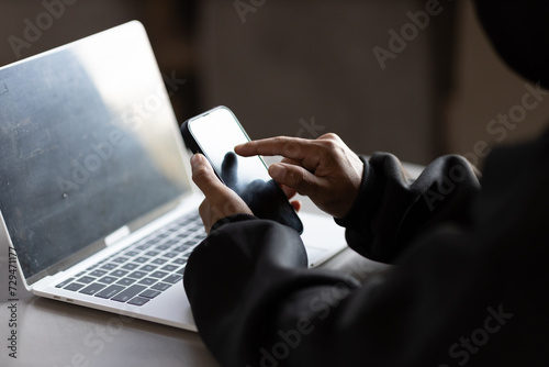 Fototapeta Naklejka Na Ścianę i Meble -  Male hacker in dark room using laptop internet hacking