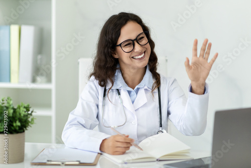 Cheerful young woman doctor have online consultation