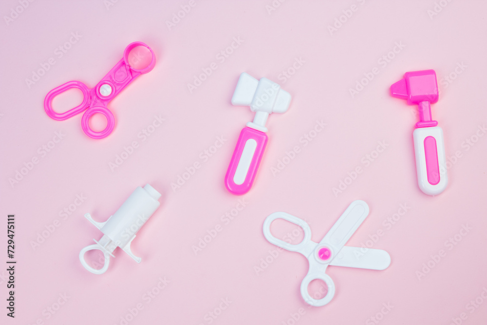 The concept of a pediatrician. Pediatrics. Toy medical devices on a pink background. Children play professional doctor. Choice of profession. Get vaccinated. The concept of a pediatrician. Pediatrics. Toy medical devices on a pink background. Children play professional doctor. Choice of profession. Get vaccinated.