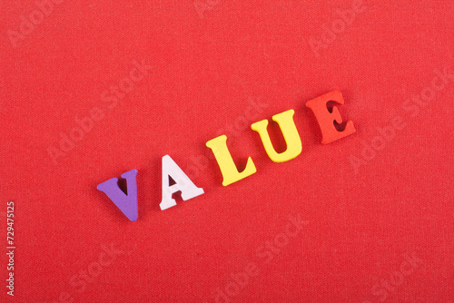 VALUE word on red background composed from colorful abc alphabet block wooden letters, copy space for ad text. Learning english concept.