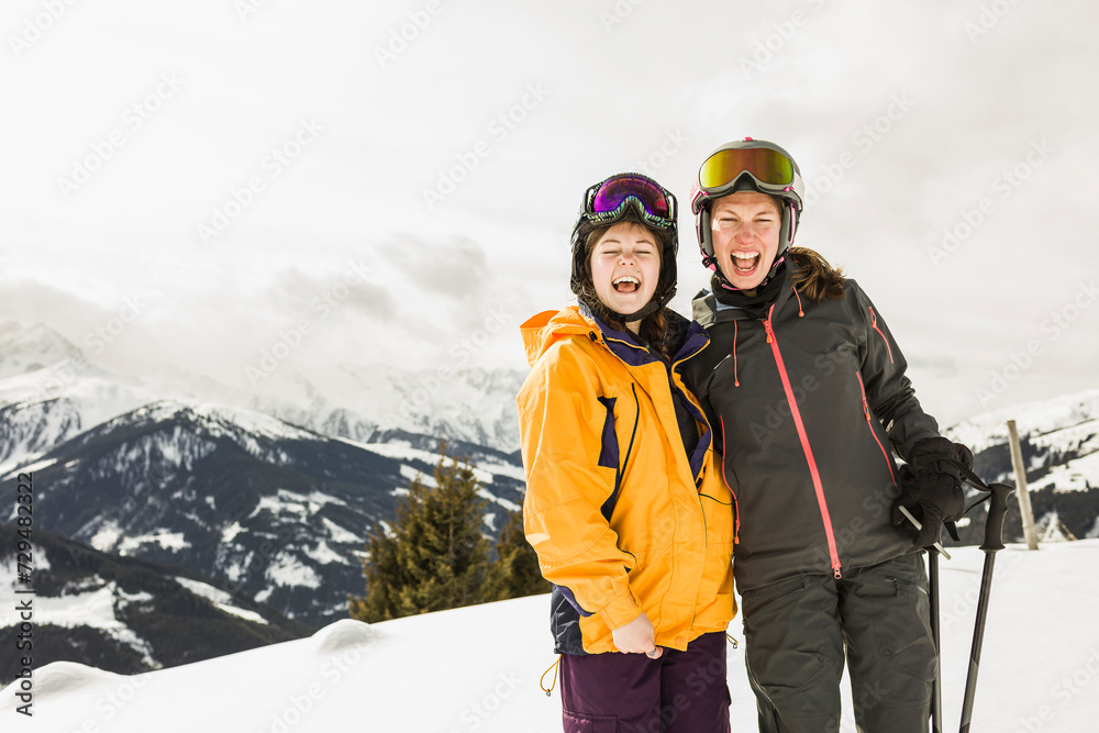 Two women dressed for skiing screaming at the camera Two women dressed for skiing screaming at the camera