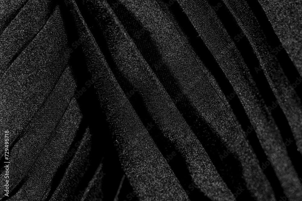 Fototapeta premium Luxury folded black silk fabric texture background close-up overlay macro elegant