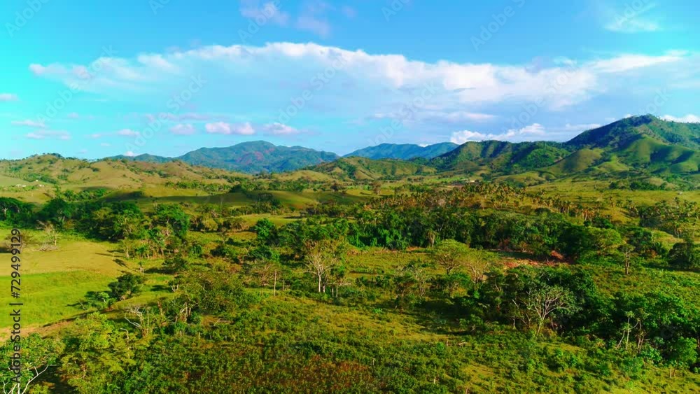 Scenic highlands of the Dominican Republic on a sunny day. Colorful green meadows, fields, trees in summer in the valley. Panoramic landscape of a mountain valley. Travel to a tropical paradise. Scenic highlands of the Dominican Republic on a sunny day. Colorful green meadows, fields, trees in summer in the valley. Panoramic landscape of a mountain valley. Travel to a tropical paradise.