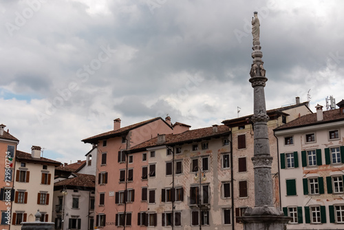 Colorful houses lining up on idyllic Piazza San Giacomo (Piazza Giacomo Matteotti or Mercato Nuovo) in city center of Udine, Friuli Venezia Giulia, Italy, Europe. Column with religious statue on top photo