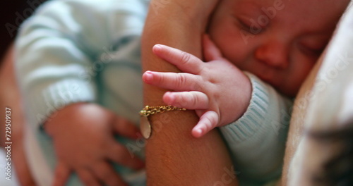 Baby hands holding into mom arms cute adorable sweet newborn closeup napping