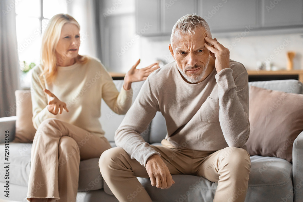 Furious senior woman yelling at her frustrated husband Furious senior woman yelling at her frustrated husband