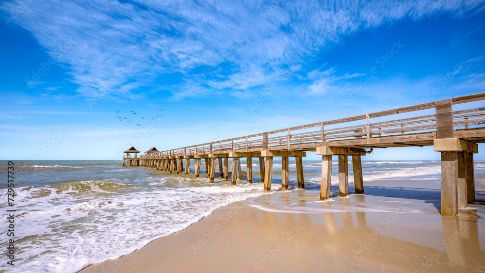 the pier of naples under a blue sky, florida