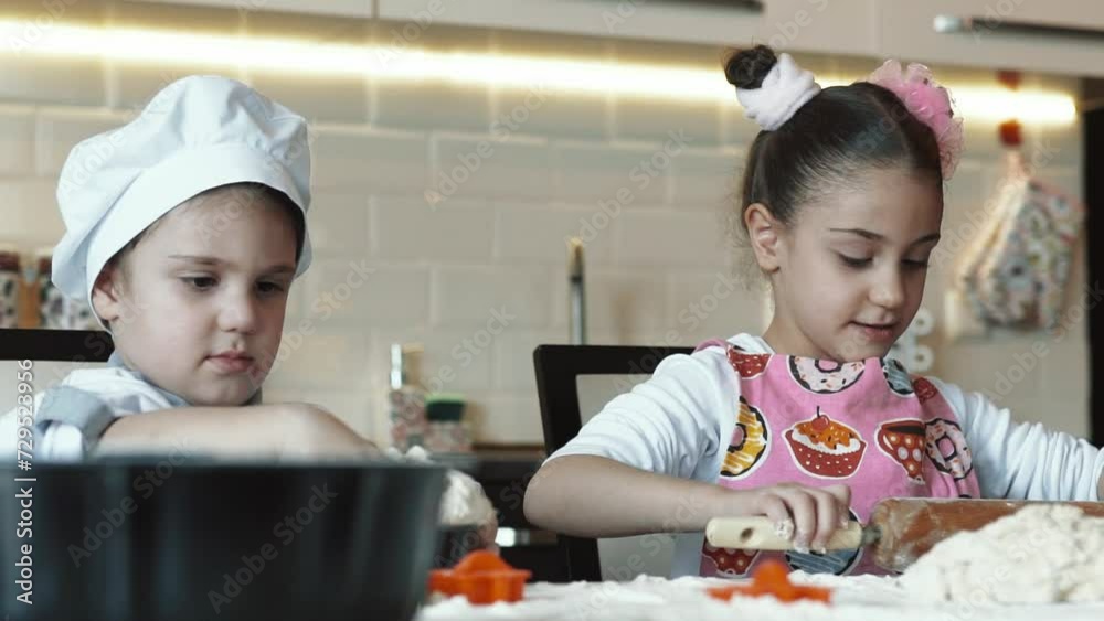 Funny kids cooking together. Brother and sister in the kitchen. Children are making cakes. Kids have fun. Children study. Funny kids cooking together. Brother and sister in the kitchen. Children are making cakes. Kids have fun. Children study.