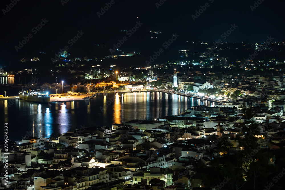 Naklejka premium Zakynthos town city at night. Harbor of Zakynthos town seen from bochali view point, Greece. Night Panorama of the Zante Zakynthos town in Greece.