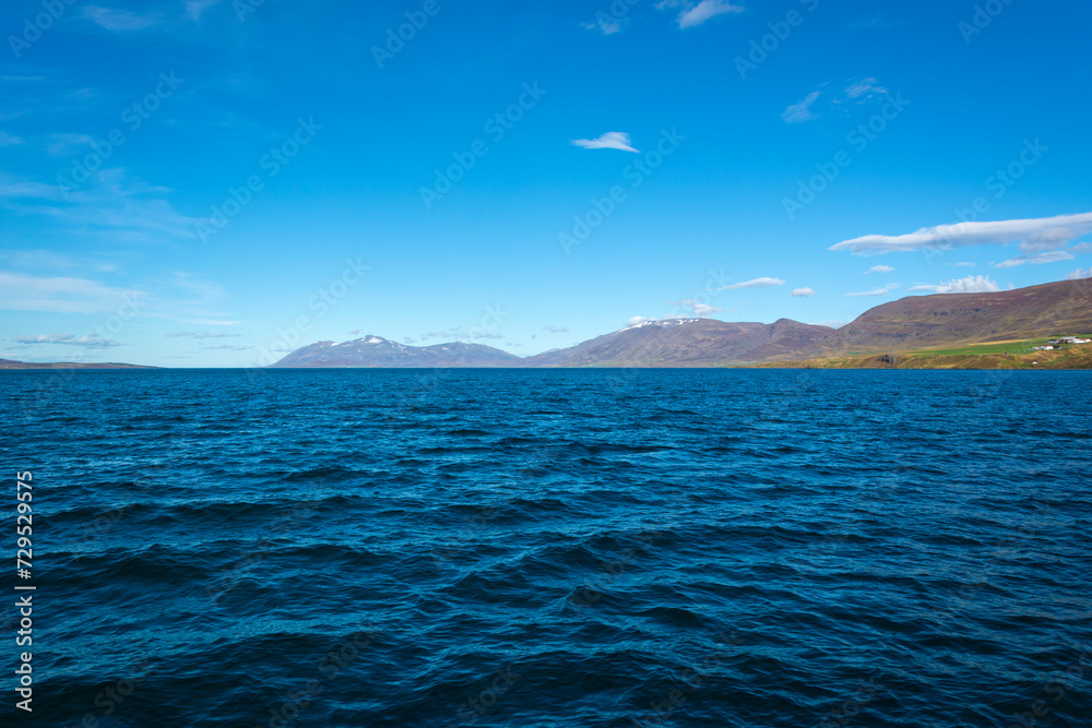 Norwegian fjord landscape with mountains and blue sky in summer