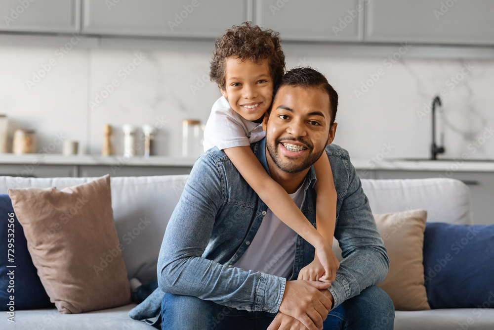 Father Son Love. Happy Black Man And Preteen Son Hugging At Home Father Son Love. Happy Black Man And Preteen Son Hugging At Home