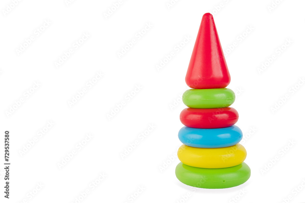 Children's multi-colored pyramid is built of bright plastic rings. Bright colored toy for the development of logic. Isolated on a white background. Children's multi-colored pyramid is built of bright plastic rings. Bright colored toy for the development of logic. Isolated on a white background.