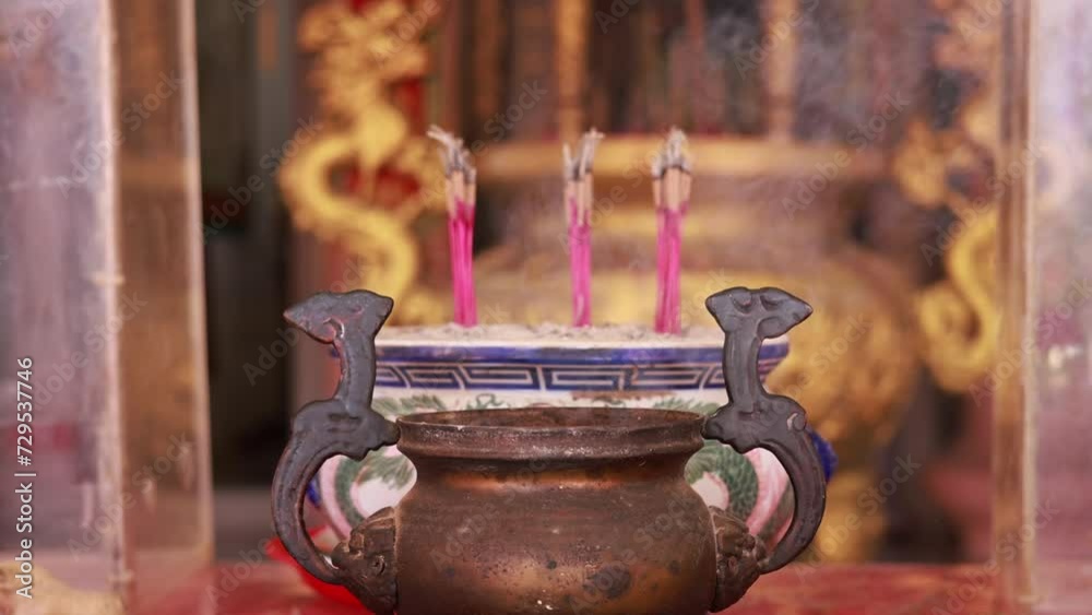incense burning in the temple with smoke to celebrate the Chinese Lunar New Year. Incense sticks burning with smoke in a Buddhist temple in Thailand incense burning in the temple with smoke to celebrate the Chinese Lunar New Year. Incense sticks burning with smoke in a Buddhist temple in Thailand