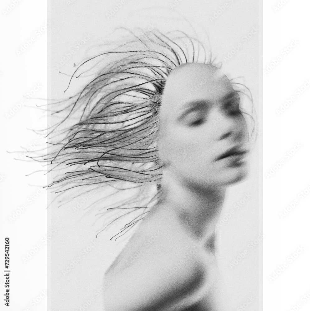 States of mind, fine-art, nature concept. Abstract and surreal woman with dry plant hair on her head portrait illustration. Applied motion blur and grain effect on model. Black and white image
