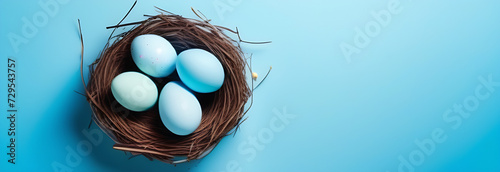 Easter poster background template with Easter eggs in the nest on light blue background. Greetings and presents for Easter Day