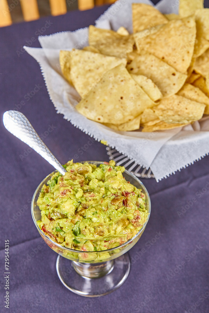 Fresh Guacamole with Tortilla Chips - Eye-Level Close-Up Fresh Guacamole with Tortilla Chips - Eye-Level Close-Up