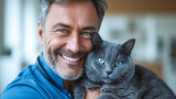 A veterinarian holds and hugs a beautiful gray cat with blue eyes in a veterinary clinic. Portrait of a smiling doctor with a cat. Pet care concept