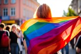 girl on her back holding a LGTB flag in the street.