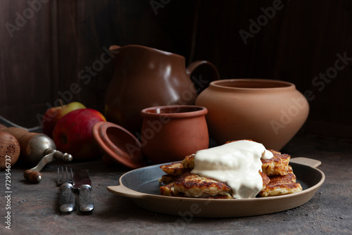 Traditional Potato Pancakes Levivot Latkes Draniki, Hash browns  with sour cream photo