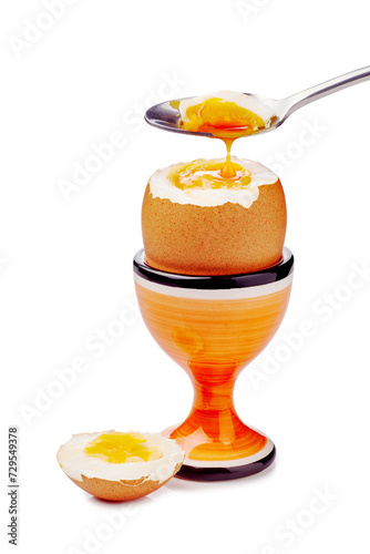 Soft-boiled egg in cup with spoon isolated on white