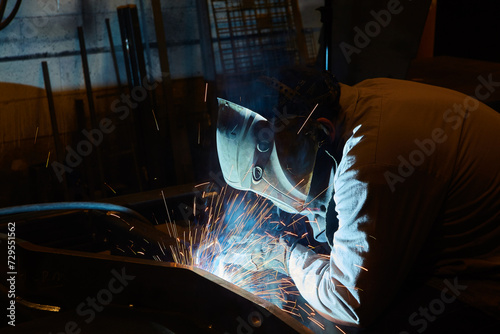 Intense Welding Sparks with Protective Gear in Workshop