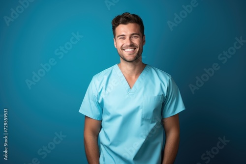 Portrait of a smiling happy male medical doctor or nurse standing isolate on blue background, Medical concept.