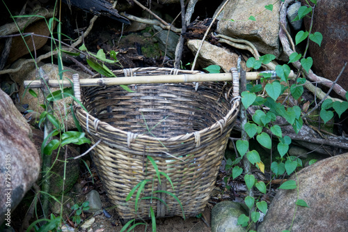 Wicker basket on the ground in the forest, natural background.