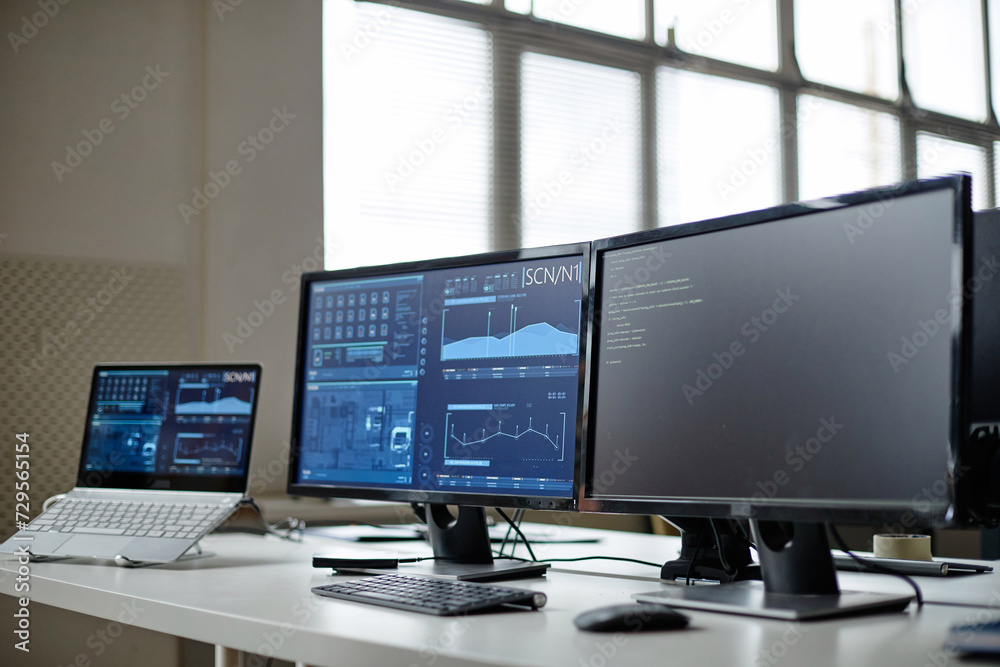 Background image of computer equipment with tech data on screens in cybersecurity office copy space Background image of computer equipment with tech data on screens in cybersecurity office copy space