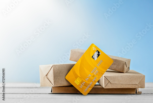 group of objects from parcels and a bank card on a wooden surface with directed sunlight