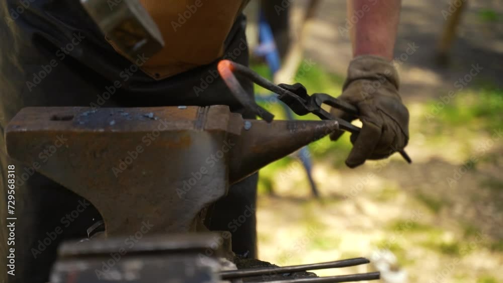 blacksmith with a hammer forges an iron part blacksmith with a hammer forges an iron part