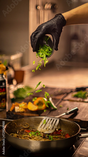 green onions are poured into a dish in a frying pan
