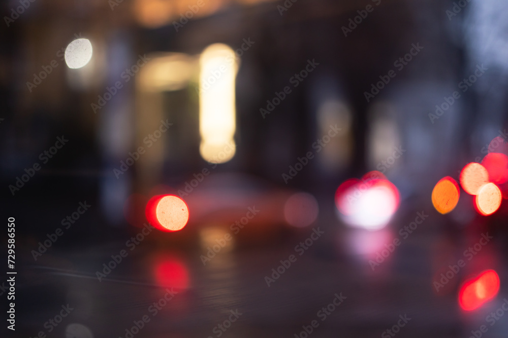 Blurred lights of the evening city. Blurred background with bokeh.