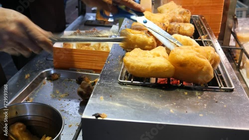 You tiao or Chinese Doughnut. Making Chinese deep-fried fluffy dough sticks. photo