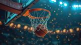 The decisive moment as a basketball falls through the net of the hoop, with a bokeh of stadium lights illuminating the night game.