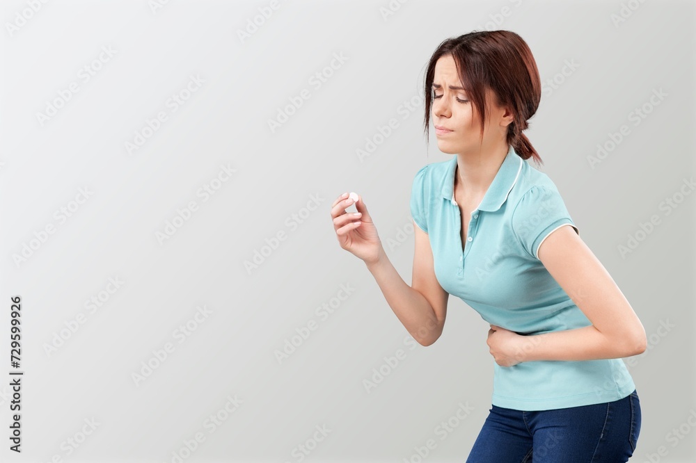 Young caucasian woman with hand on stomach painful feeling unwell. Young caucasian woman with hand on stomach painful feeling unwell.