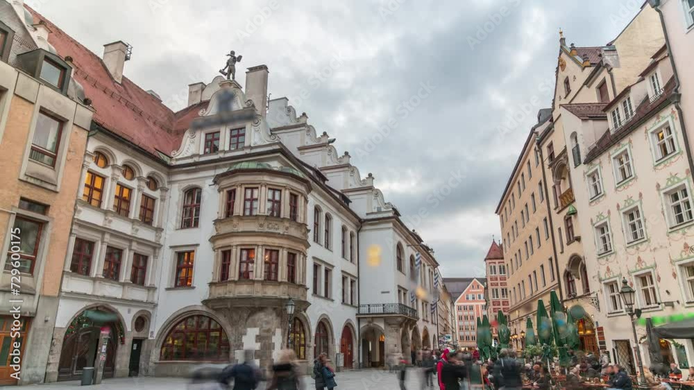 Cityscape with bier houses and restaurants outdoors on Platzl timelapse in Munich, Bayern, Germany. Walking area with tables and chairs. People relaxing in cafes