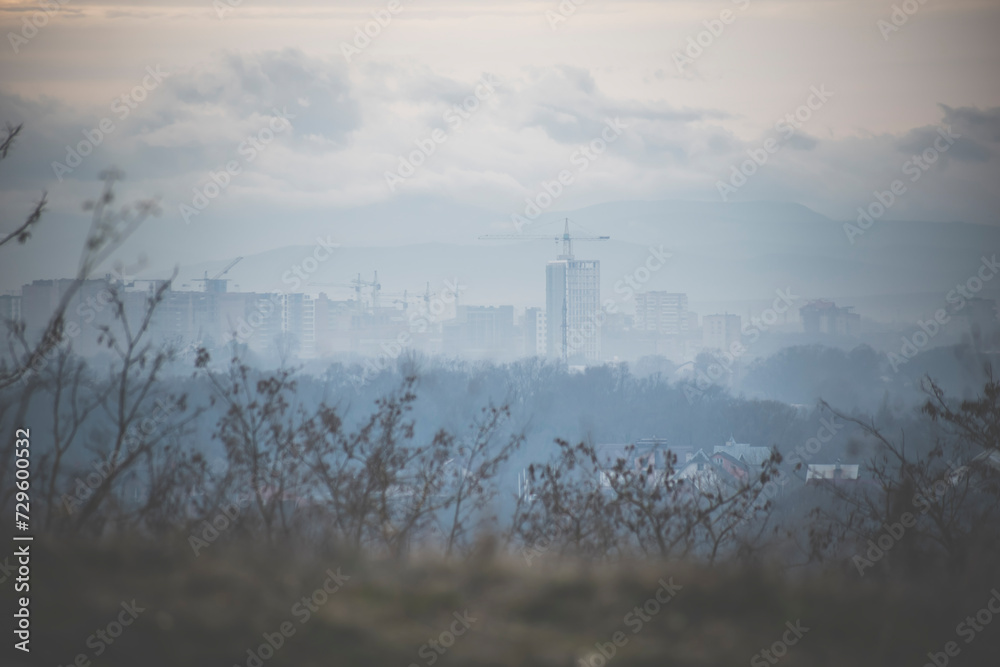 the city in the fog. photo of the city from a high mountain