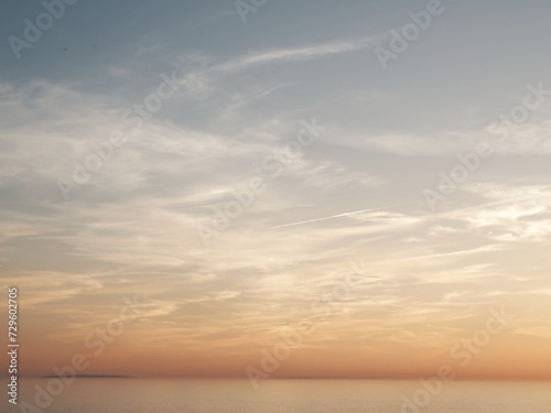 Sunset over the northern sea with clouds in the background. © macizogalaico